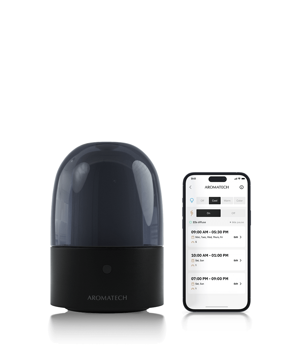 AromaDream Diffuser next to smartphone with AromaTech app